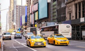 New York, streets. High buildings, colorful signs, cars and cabs